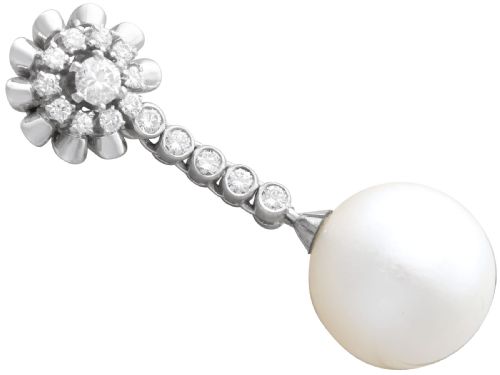 fig 4. A pair of 18ct white gold drop earrings featuring round South Sea pearls suspended from articulated diamond stems and floral cluster stud tops.