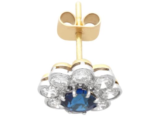 fig 5. A pair of antique floral-shaped cluster earrings featuring central round blue sapphires encircled by bright diamonds.