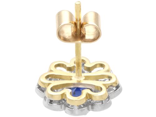 fig 6. A pair of antique floral-shaped cluster earrings featuring central round blue sapphires encircled by bright diamonds.