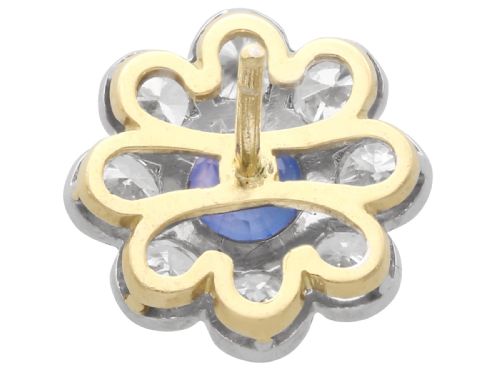 fig 7. A pair of antique floral-shaped cluster earrings featuring central round blue sapphires encircled by bright diamonds.