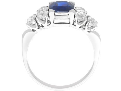 fig 4. An Art Deco platinum ring featuring a central cushion-cut blue sapphire flanked by three round diamonds on each shoulder.
