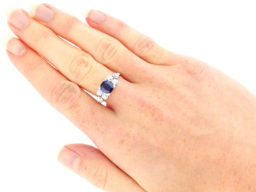 fig 5. An Art Deco platinum ring featuring a central cushion-cut blue sapphire flanked by three round diamonds on each shoulder.