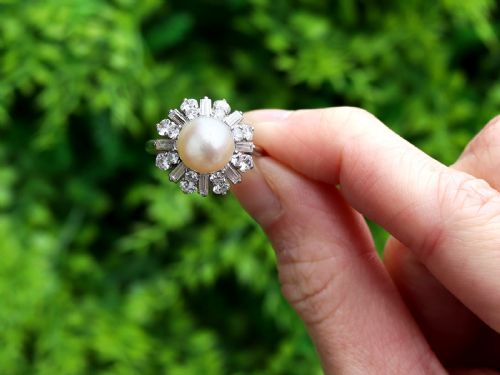 fig 1. A platinum cluster ring featuring a central white cultured pearl surrounded by a starburst halo of baguette and brilliant-cut diamonds.
