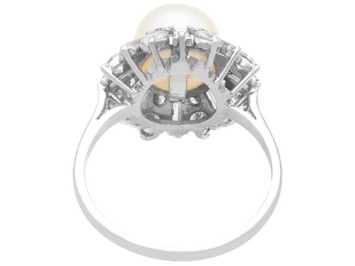 fig 5. A platinum cluster ring featuring a central white cultured pearl surrounded by a starburst halo of baguette and brilliant-cut diamonds.