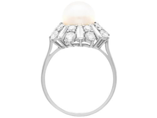 fig 6. A platinum cluster ring featuring a central white cultured pearl surrounded by a starburst halo of baguette and brilliant-cut diamonds.