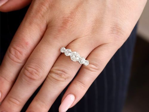 fig 2. An 18ct yellow gold five stone ring set with five graduated round diamonds in claw settings.