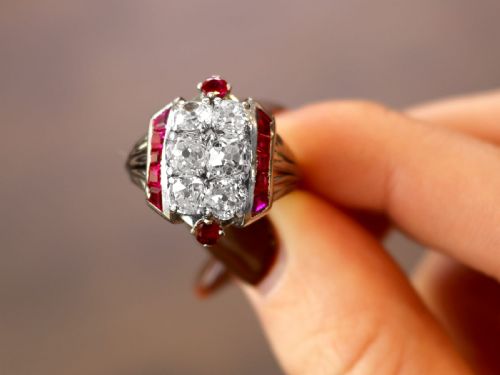 fig 1. An Art Deco 18ct white gold dress ring featuring a central cluster of old-cut diamonds flanked by channel-set calibre rubies.