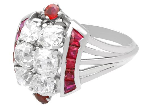 fig 3. An Art Deco 18ct white gold dress ring featuring a central cluster of old-cut diamonds flanked by channel-set calibre rubies.