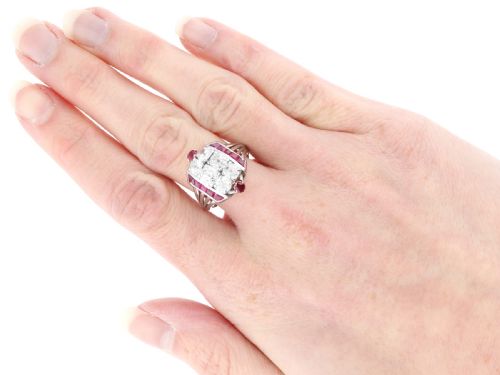 fig 7. An Art Deco 18ct white gold dress ring featuring a central cluster of old-cut diamonds flanked by channel-set calibre rubies.