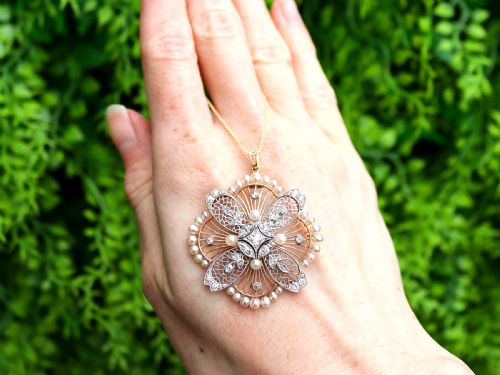 fig 1. An openwork circular Edwardian floral pendant brooch crafted in rose gold and platinum, set with central diamonds and a perimeter of natural pearls.