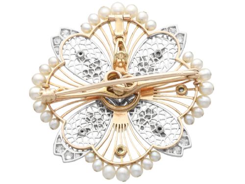 fig 9. An openwork circular Edwardian floral pendant brooch crafted in rose gold and platinum, set with central diamonds and a perimeter of natural pearls.