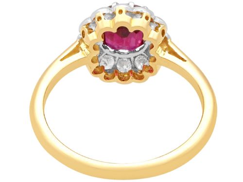 fig 5. An 18ct yellow gold cluster ring featuring a central cushion cut red ruby framed by a halo of round diamonds.