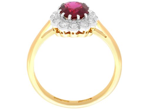 fig 6. An 18ct yellow gold cluster ring featuring a central cushion cut red ruby framed by a halo of round diamonds.