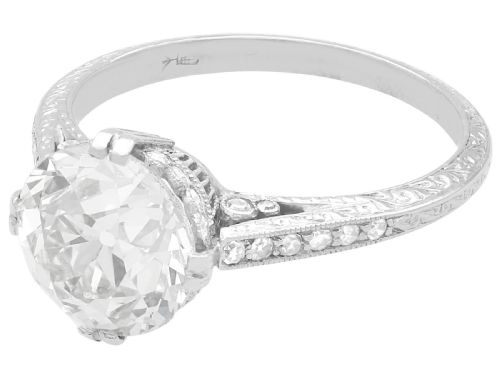fig 1. A platinum solitaire ring featuring a large round diamond secured by multi-claw prongs on a hand-engraved decorative band.