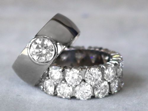 fig 1. A vintage 14ct white gold wide band ring featuring a central bezel-set round brilliant diamond.