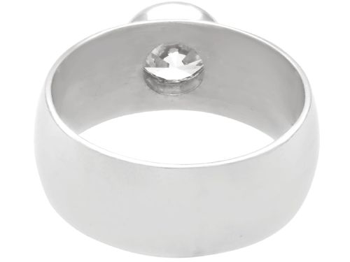 fig 3. A vintage 14ct white gold wide band ring featuring a central bezel-set round brilliant diamond.