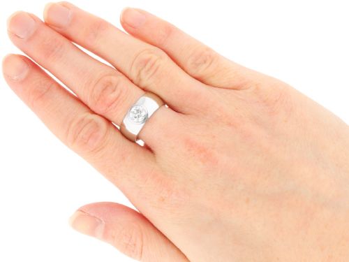 fig 5. A vintage 14ct white gold wide band ring featuring a central bezel-set round brilliant diamond.