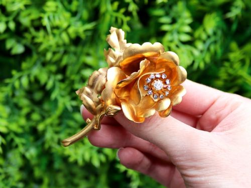 fig 1. An antique Victorian 22ct yellow gold floral brooch featuring sculpted petals, leaf details, and a central cluster of diamonds.