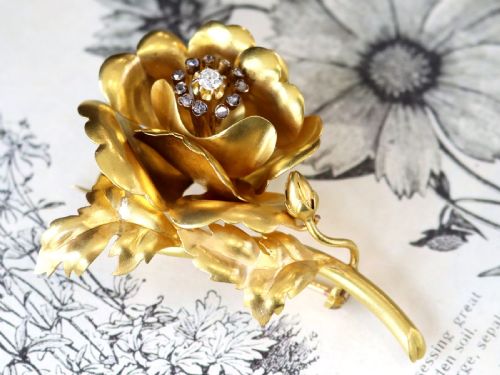 fig 3. An antique Victorian 22ct yellow gold floral brooch featuring sculpted petals, leaf details, and a central cluster of diamonds.