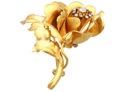 fig 4. An antique Victorian 22ct yellow gold floral brooch featuring sculpted petals, leaf details, and a central cluster of diamonds.