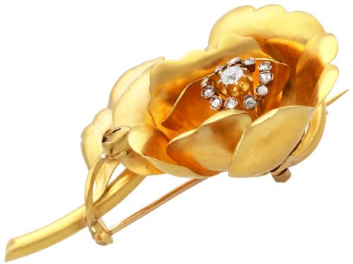 fig 5. An antique Victorian 22ct yellow gold floral brooch featuring sculpted petals, leaf details, and a central cluster of diamonds.