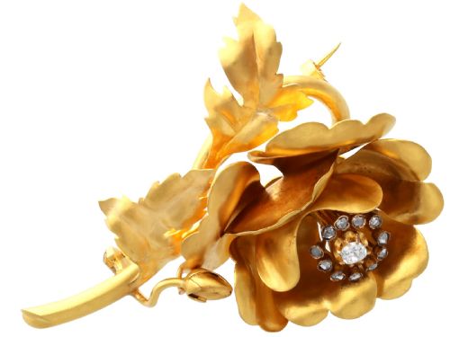fig 6. An antique Victorian 22ct yellow gold floral brooch featuring sculpted petals, leaf details, and a central cluster of diamonds.