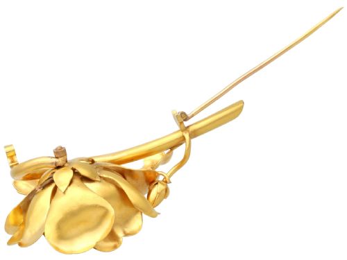 fig 8. An antique Victorian 22ct yellow gold floral brooch featuring sculpted petals, leaf details, and a central cluster of diamonds.