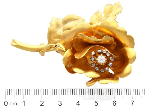 fig 9. An antique Victorian 22ct yellow gold floral brooch featuring sculpted petals, leaf details, and a central cluster of diamonds.