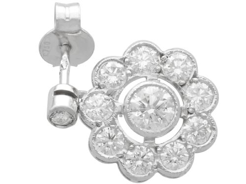 fig 3. A pair of Art Deco 18ct white gold drop earrings featuring a circular diamond cluster motif suspended from a single bezel-set diamond surmount.