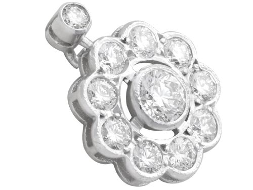 fig 4. A pair of Art Deco 18ct white gold drop earrings featuring a circular diamond cluster motif suspended from a single bezel-set diamond surmount.