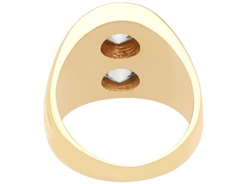fig 4. A wide 14ct yellow gold ring featuring two round diamonds set vertically within carved linear accents.