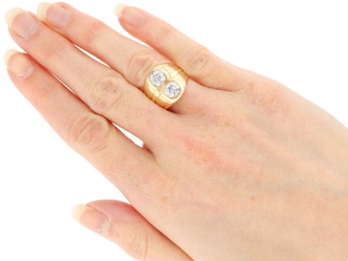 fig 6. A wide 14ct yellow gold ring featuring two round diamonds set vertically within carved linear accents.