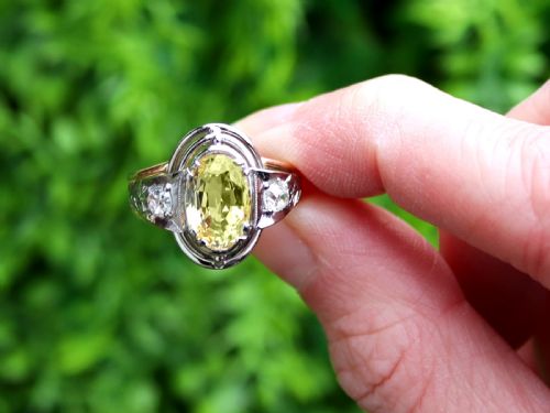 fig 1. An Art Deco 18ct yellow gold and platinum ring featuring a central oval yellow sapphire flanked by single diamonds.