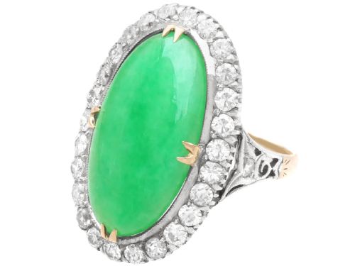 fig 4. An antique Edwardian ring featuring a large oval green jadeite cabochon encircled by a halo of round diamonds on a gold band.