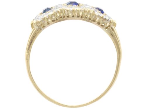 fig 6. An antique 18ct yellow gold ring featuring three rectangular cushion-cut blue sapphires surrounded by a halo of old-cut diamonds.