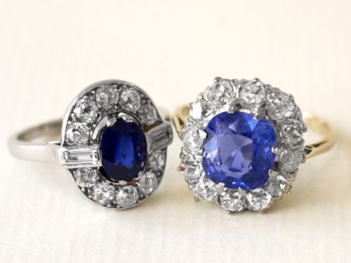 fig 2. An antique Art Deco ring featuring a cushion-cut blue sapphire central stone surrounded by a cluster halo of round diamonds set on a yellow gold band.