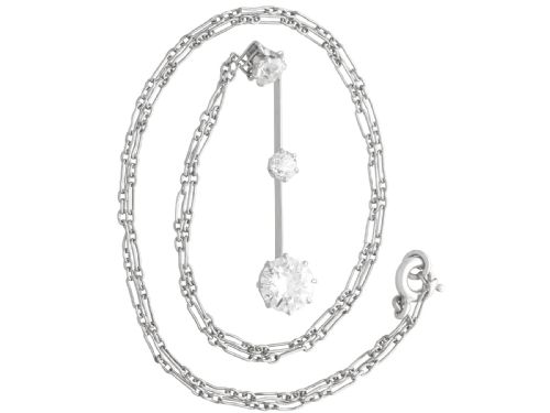 fig 3. An 18ct white gold Art Deco pendant featuring three linear claw-set round diamonds suspended on a delicate chain.