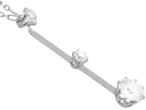 fig 4. An 18ct white gold Art Deco pendant featuring three linear claw-set round diamonds suspended on a delicate chain.