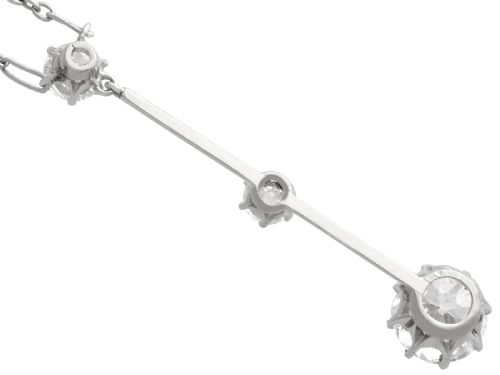 fig 5. An 18ct white gold Art Deco pendant featuring three linear claw-set round diamonds suspended on a delicate chain.