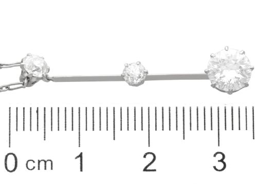 fig 6. An 18ct white gold Art Deco pendant featuring three linear claw-set round diamonds suspended on a delicate chain.
