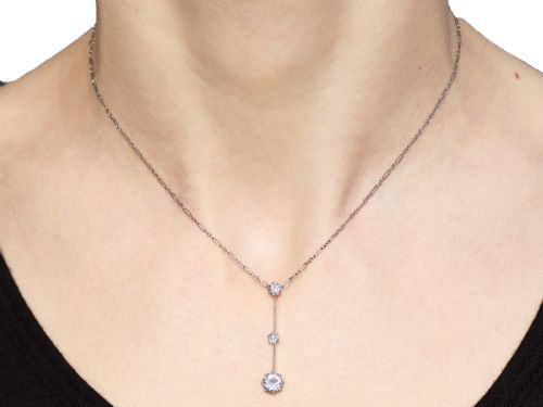 fig 7. An 18ct white gold Art Deco pendant featuring three linear claw-set round diamonds suspended on a delicate chain.