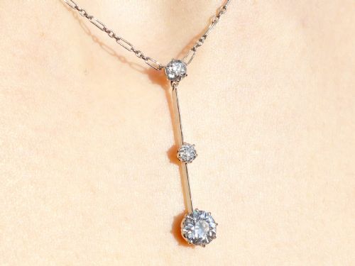 fig 8. An 18ct white gold Art Deco pendant featuring three linear claw-set round diamonds suspended on a delicate chain.