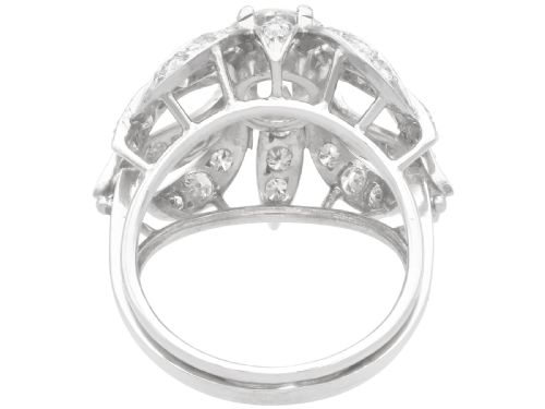 fig 5. A platinum dress ring featuring a central round brilliant cut diamond surrounded by openwork diamond-set petal motifs.