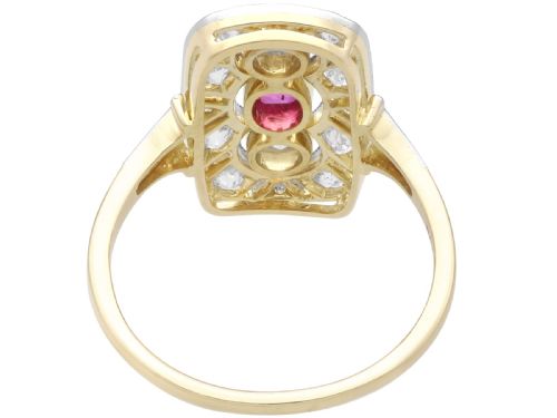fig 5. An Art Deco 14ct yellow gold dress ring featuring a central oval red ruby set within a rectangular pierced openwork plaque adorned with round diamonds and millegrain edging.