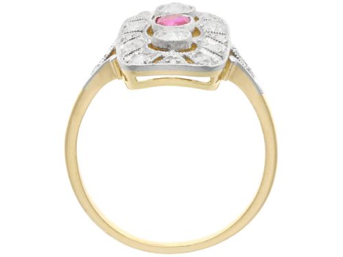 fig 6. An Art Deco 14ct yellow gold dress ring featuring a central oval red ruby set within a rectangular pierced openwork plaque adorned with round diamonds and millegrain edging.