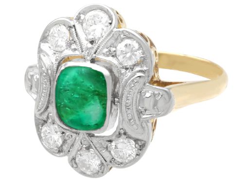 fig 4. An Art Deco dress ring featuring a central cushion-cut green emerald surrounded by a geometric pierced diamond halo set in white metal on an 18ct yellow gold band.