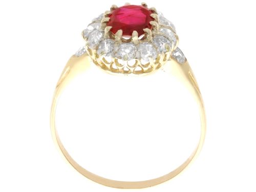 fig 6. An 18ct yellow gold ring featuring a central oval faceted ruby surrounded by a halo of twelve old cut diamonds in claw settings.