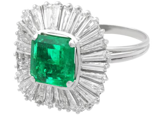 fig 3. A 1950s platinum ballerina ring featuring a central rectangular emerald surrounded by a radiating fan of channel-set baguette cut diamonds.