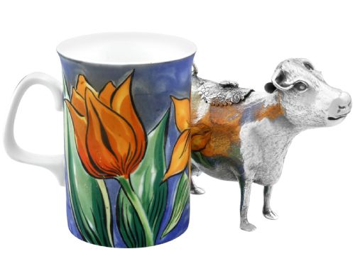 fig 3. An antique sterling silver cow creamer featuring textured hide detailing, a looped tail handle, and a floral hinged lid on its back.