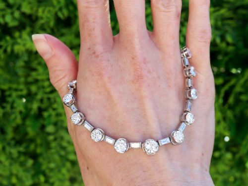 fig 1. An antique Art Deco platinum necklace set with alternating round cut and baguette cut diamonds linked in a continuous line.
